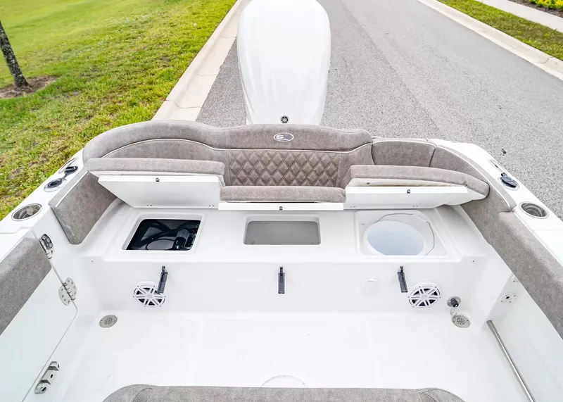 Slide: The Image of The image shows the cockpit of a Sea Hunt Ultra 245 SE boat with cushioned seats and speakers. - 10