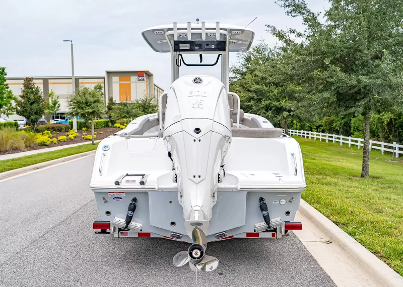 Slide: The Image of The image shows a 2027 Sea Hunt Ultra 245 SE boat parked on a street. - 4