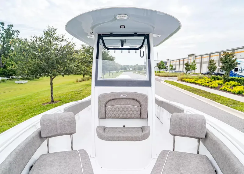 Slide: The Image of The image shows the cockpit of a 2027 Sea Hunt Ultra 245 SE boat with gray upholstery. - 24