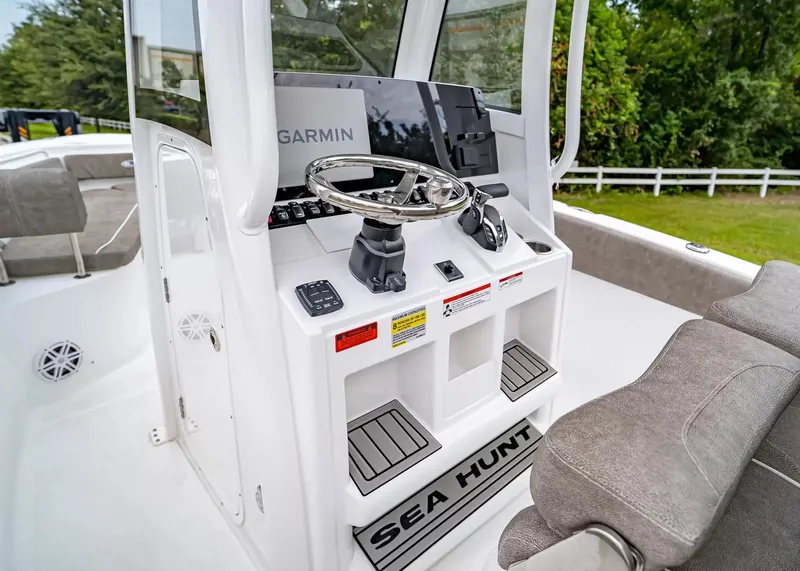 Slide: The Image of The image shows the helm of a Sea Hunt Ultra 245 SE boat with a Garmin system. - 17
