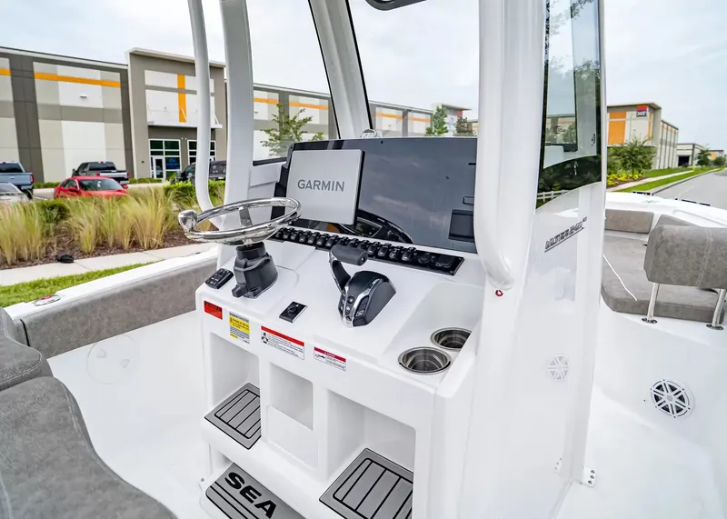 Slide: The Image of The image shows the cockpit of a 2027 Sea Hunt Ultra 245 SE boat with modern electronics. - 18