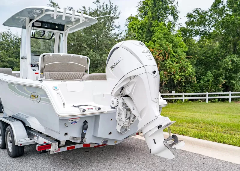 Slide: The Image of A 2027 Sea Hunt Ultra 245 SE boat with a Yamaha outboard motor, parked on a trailer. - 5