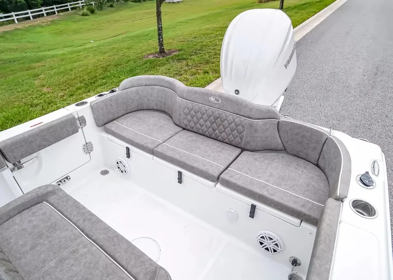 Slide: The Image of The image shows the stern of a Sea Hunt Ultra 245 SE boat with gray cushions and speakers. - 7