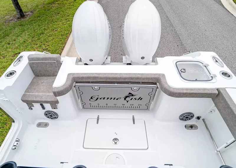 Slide: The Image of The image shows the stern of a Sea Hunt Gamefish 25 boat with two engines. - 11