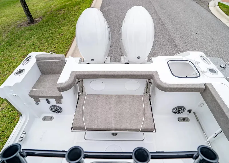 Slide: The Image of The image shows the stern of a Sea Hunt Gamefish 25 boat with dual engines and seating. - 5