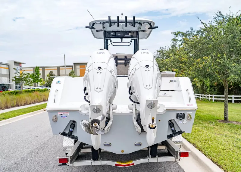 Slide: The Image of The image shows a 2026 Sea Hunt Gamefish 25 boat with two outboard engines. - 3