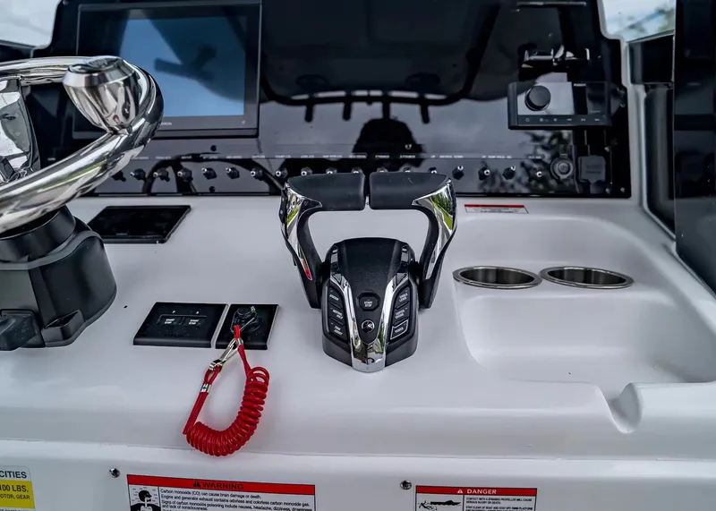 Slide: The Image of The image shows the helm of a Sea Hunt Gamefish 25 boat with modern controls. - 17