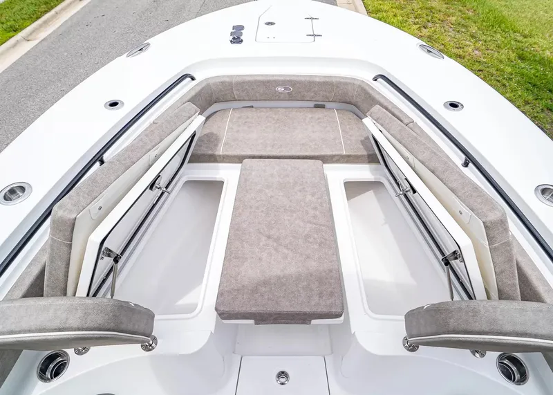 Slide: The Image of The image shows the bow area of a 2026 Sea Hunt Gamefish 25 boat with cushioned seating. - 26