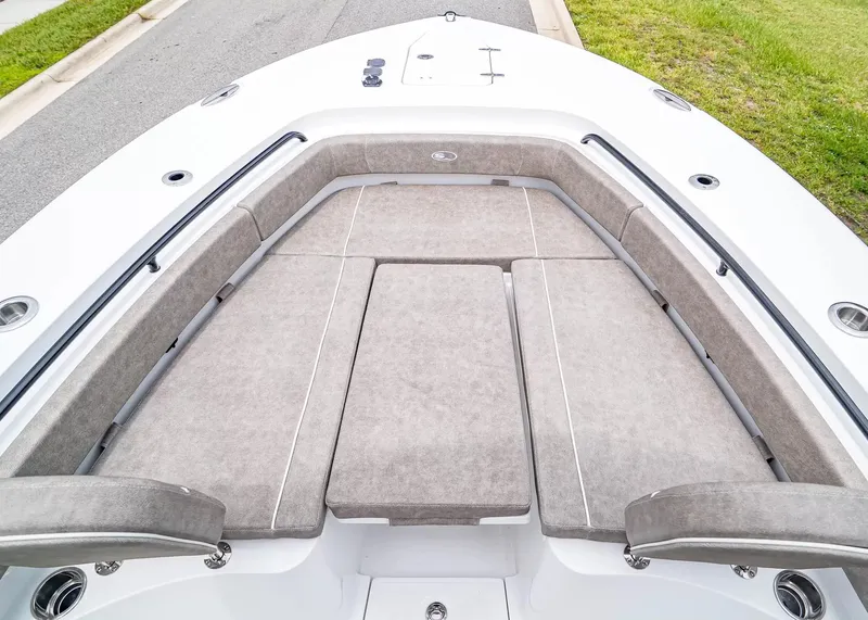 Slide: The Image of The image shows the bow area of a 2026 Sea Hunt Gamefish 25 with cushioned seating. - 25