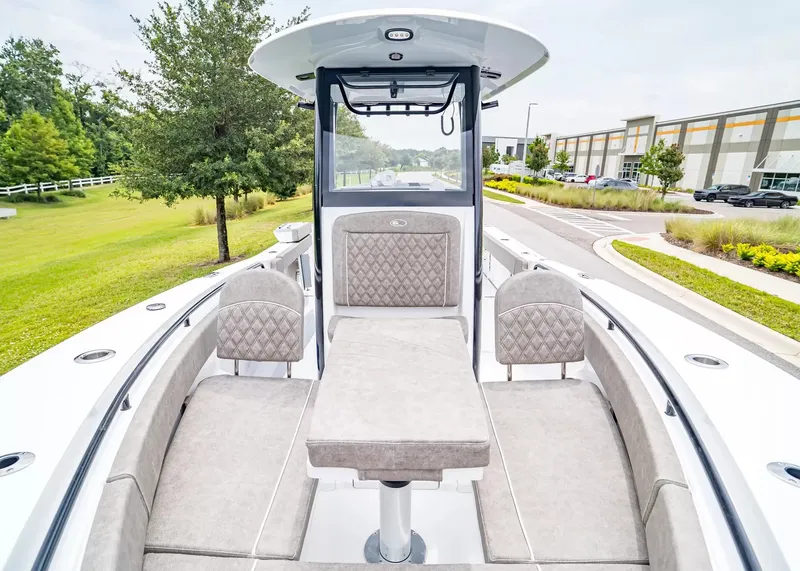 Slide: The Image of The image shows the cockpit of a 2026 Sea Hunt Gamefish 25 with cushioned seating. - 24