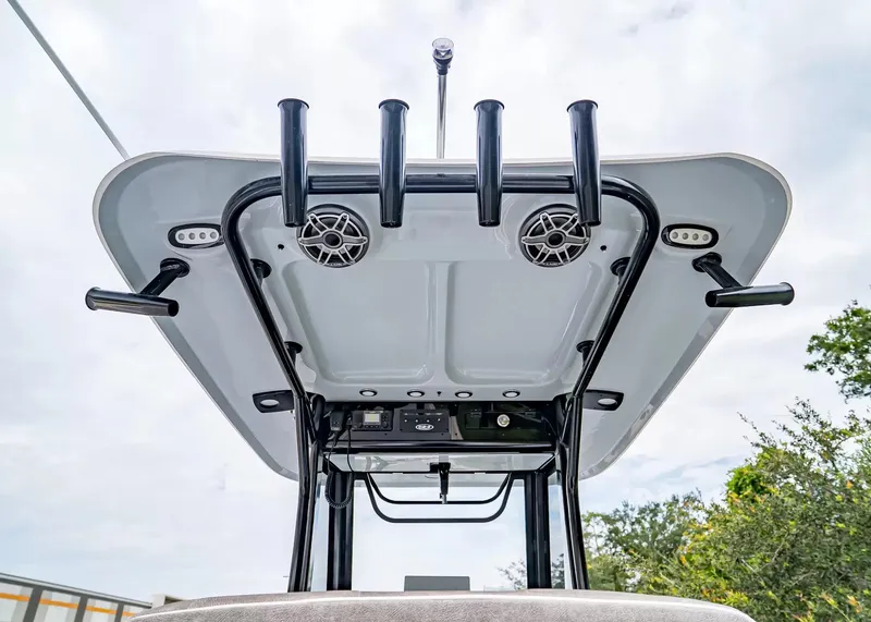 Slide: The Image of The image shows the T-top of a Sea Hunt Gamefish 25 boat with speakers and rod holders. - 15