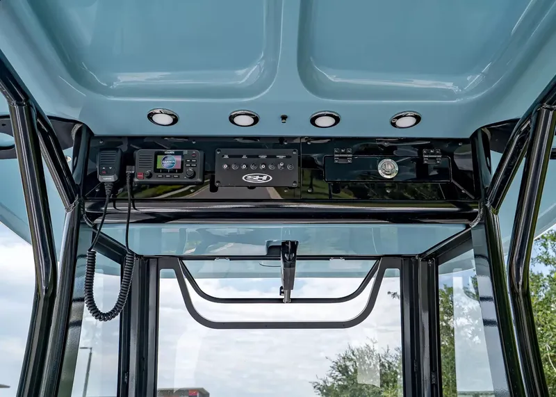 Slide: The Image of The image shows the helm of a Sea Hunt Gamefish 27 Coffin Box boat. It features electronic devices and controls. - 16