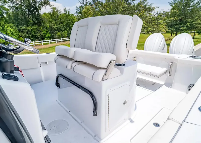 Slide: The Image of The 2027 Sea Hunt Gamefish 27 Coffin Box features a luxurious, cushioned bench seat in the cockpit. - 20