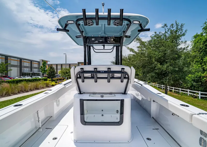 Slide: The Image of The image shows the cockpit of a 2027 Sea Hunt Gamefish 27 Coffin Box boat. It features a modern console with multiple rod holders and a large storage area. - 12