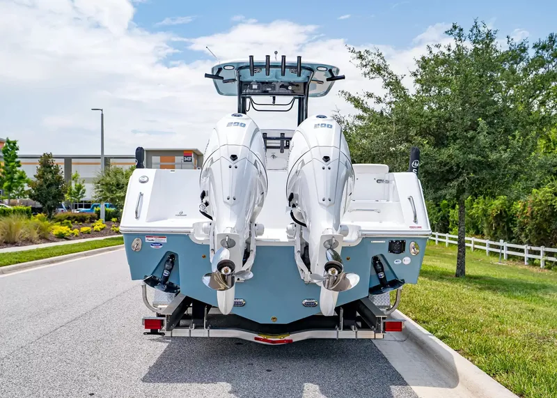 Slide: The Image of The image shows a 2027 Sea Hunt Gamefish 27 Coffin Box boat with twin outboard engines. - 4