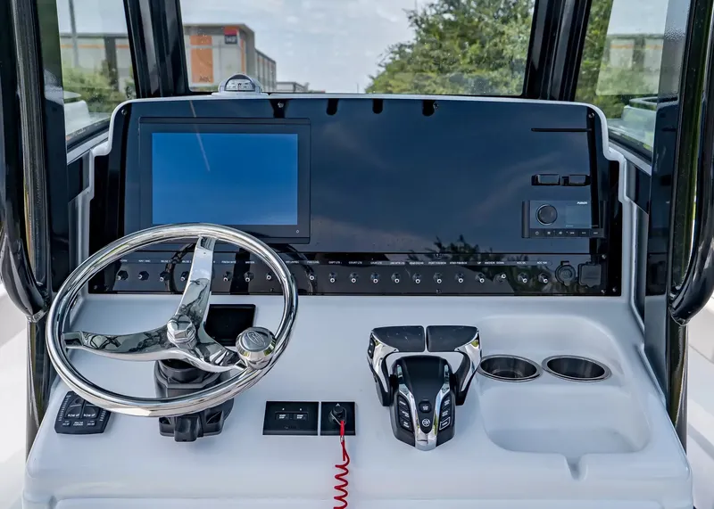 Slide: The Image of The image shows the helm of a Sea Hunt Gamefish 27 Coffin Box boat with modern instruments. - 17