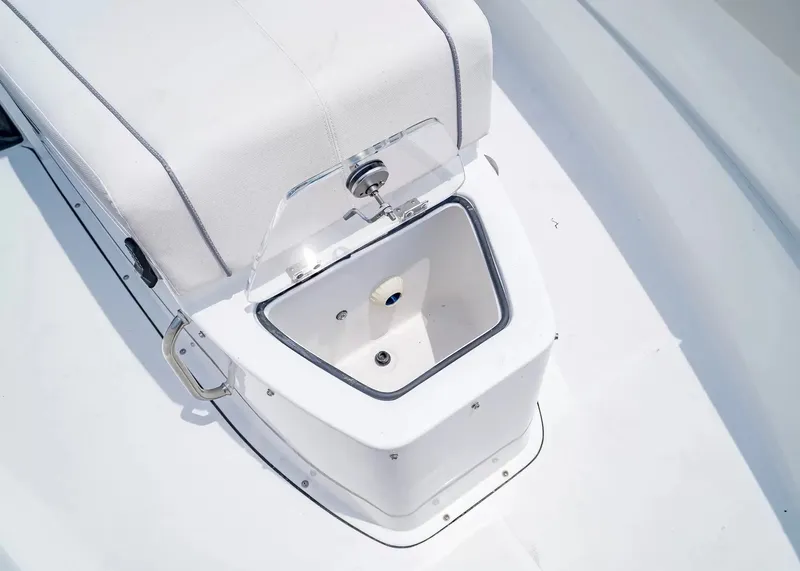 Slide: The Image of A white boat hull with an open storage compartment and cushioned seating. - 25
