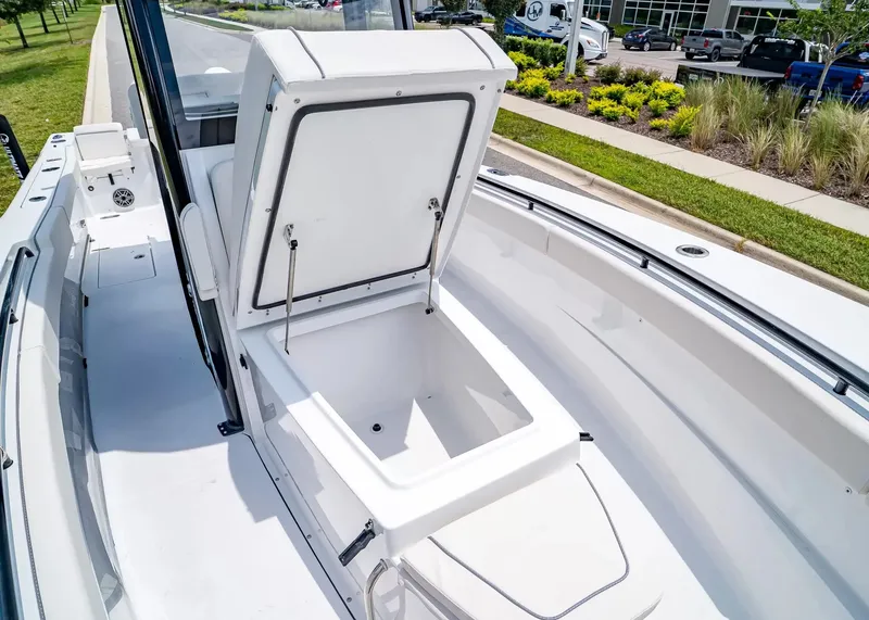 Slide: The Image of The image shows the open storage compartment of a 2027 Sea Hunt Gamefish 27 Coffin Box boat. - 24