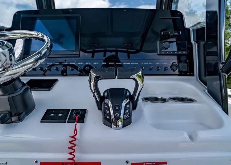 Slide: The Image of The image shows the helm of a Sea Hunt Gamefish 27 Coffin Box boat. It features modern controls and screens. - 19