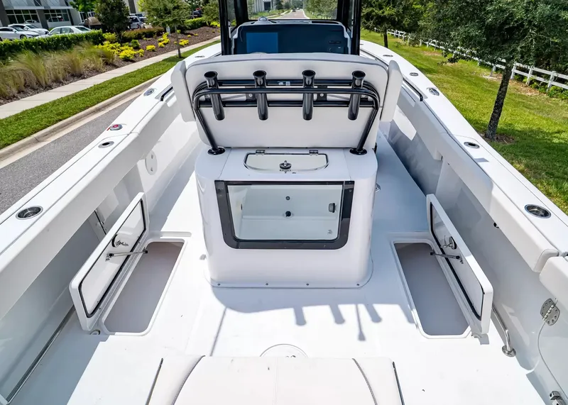 Slide: The Image of The image shows the deck of a Sea Hunt Gamefish 27 Coffin Box boat. It features multiple storage compartments and a central box. - 11