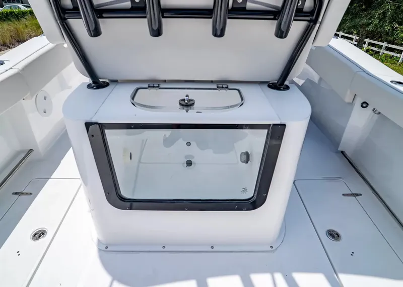 Slide: The Image of The image shows the interior of a Sea Hunt Gamefish 27 Coffin Box boat with a large storage area. - 13