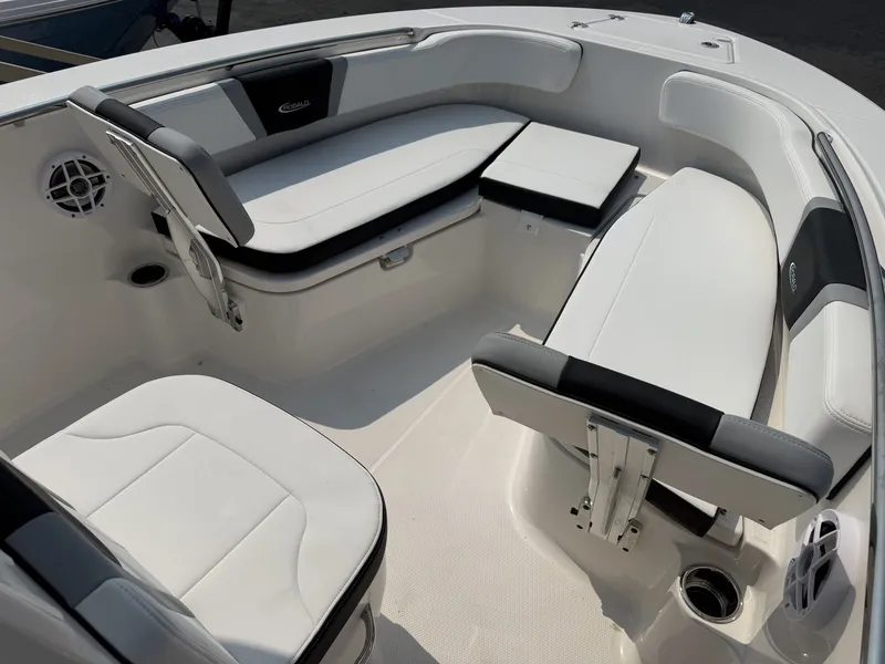 Slide: The Image of The image shows the seating area of a Robalo R200 Center Console boat with white upholstery. - 5