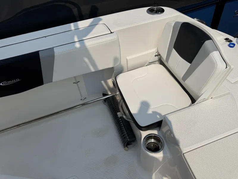 Slide: The Image of The image shows the seating area of a Robalo R200 Center Console boat with white and black upholstery. - 9
