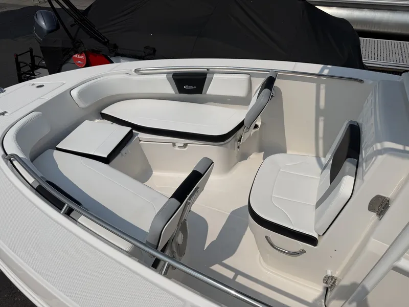 Slide: The Image of The image shows the bow area of a Robalo R200 Center Console boat with white and black seating. - 4