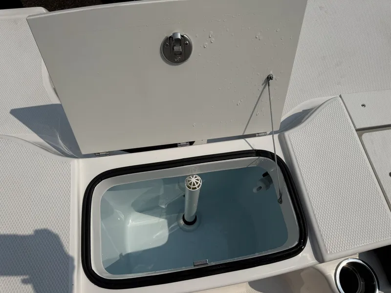 Slide: The Image of An open storage compartment on a 2027 Robalo R200 Center Console boat. - 11