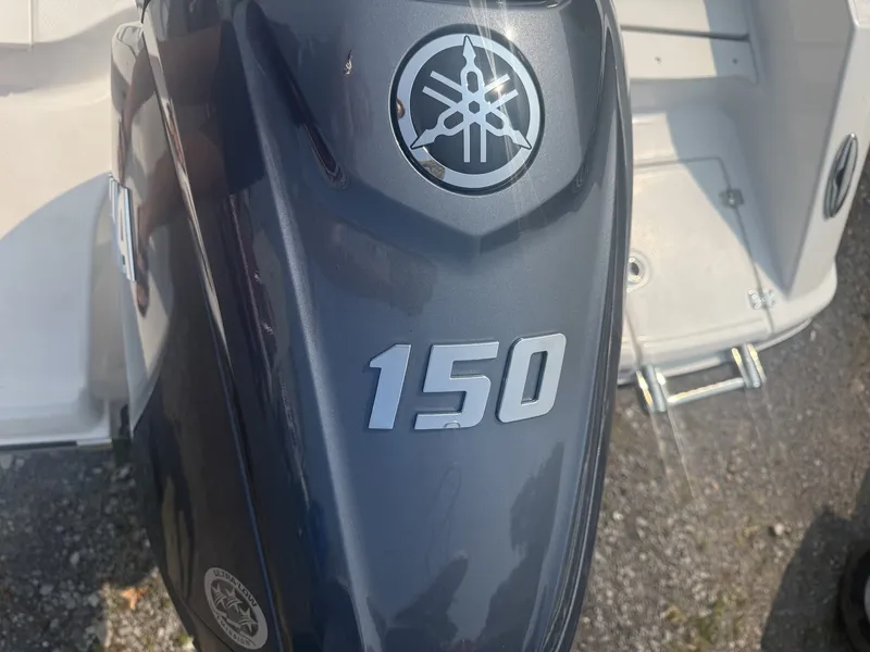 Slide: The Image of A Yamaha 150 outboard motor is mounted on a boat sitting on a trailer. - 13