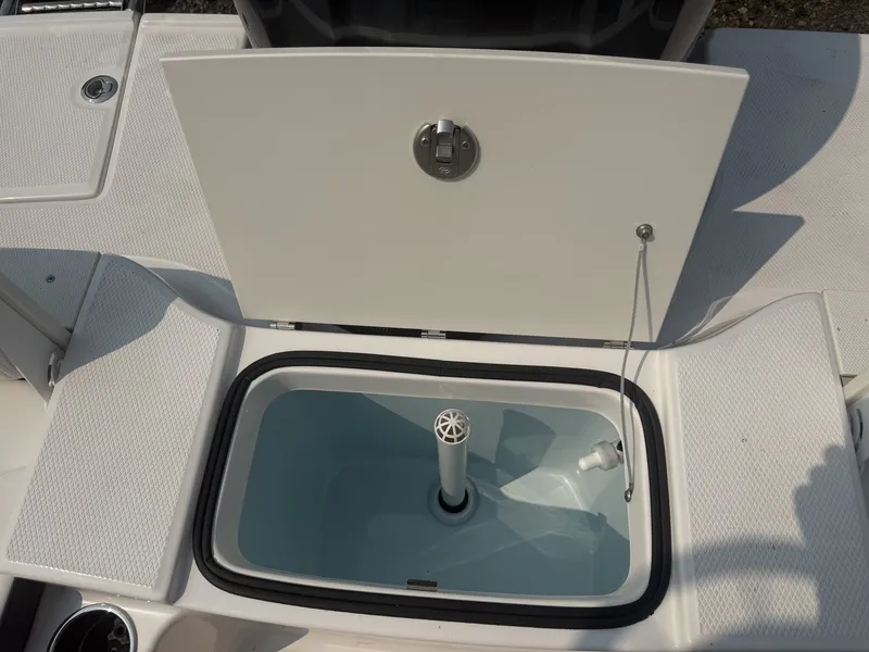 Slide: The Image of An open storage compartment on a 2027 Robalo R200 Center Console boat. - 10