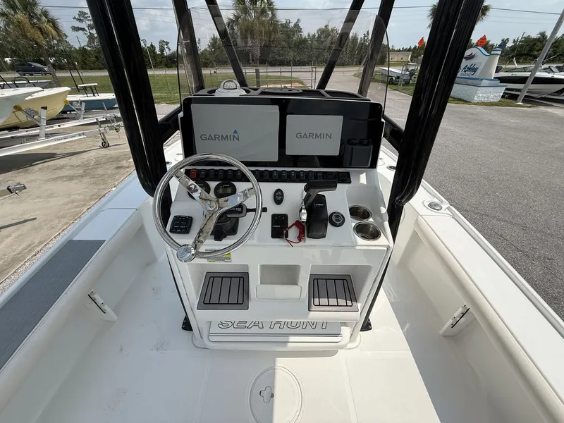 Slide: The Image of The image shows the cockpit of a Sea Hunt BX Series 22 boat with Garmin screens. - 12