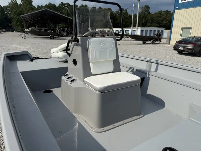 Slide: The Image of The image shows the cockpit of a G3 Bay 18 BAY-F90 SHO boat with a central console and white seating. - 6