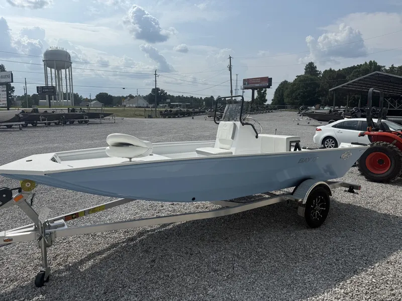 Slide: The Image of A white G3 Bay 17 boat on an aluminum trailer is parked on a gravel lot. - 3