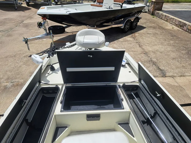 Slide: The Image of The image shows the deck of a 2022 Ranger RB190 boat with open storage compartments. - 14