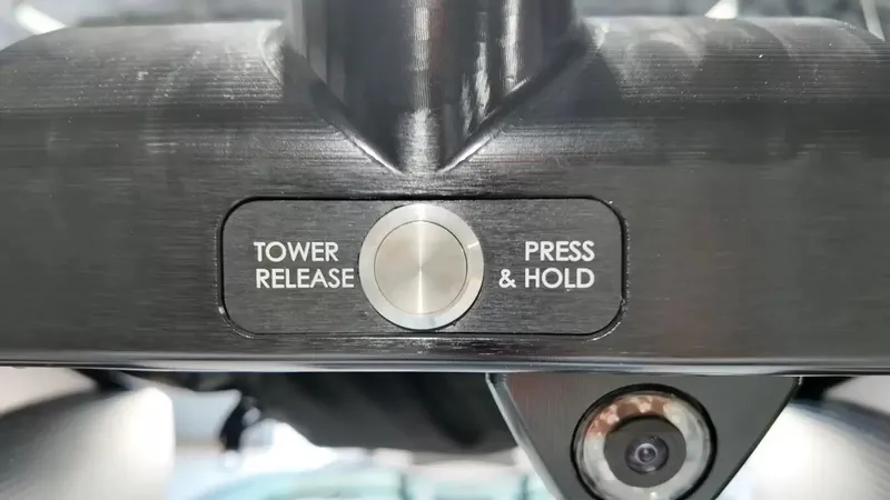 Slide: The Image of Close-up of a button labeled "Tower Release Press & Hold" on a 2024 MasterCraft XStarS. - 37