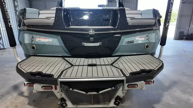 Slide: The Image of The image shows the rear of a 2024 MasterCraft XStarS boat in a warehouse. - 7
