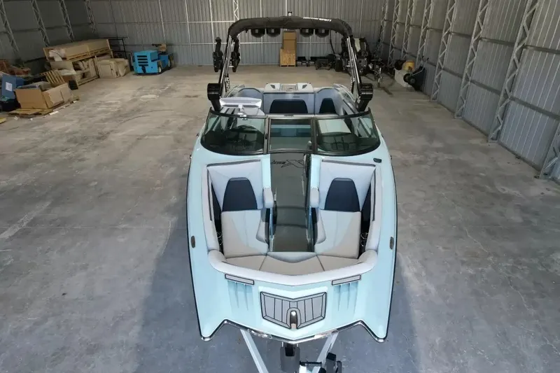 Slide: The Image of A 2024 MasterCraft XStarS boat in a warehouse, featuring sleek design and comfortable seating. - 18