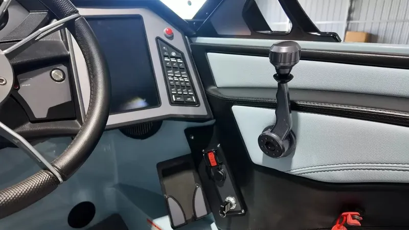 Slide: The Image of The image shows the cockpit of a 2024 MasterCraft XStarS with a modern steering wheel and digital display. - 50