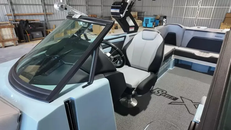Slide: The Image of The image shows the cockpit of a 2024 MasterCraft XStarS with modern seating and a stylish steering wheel. - 43