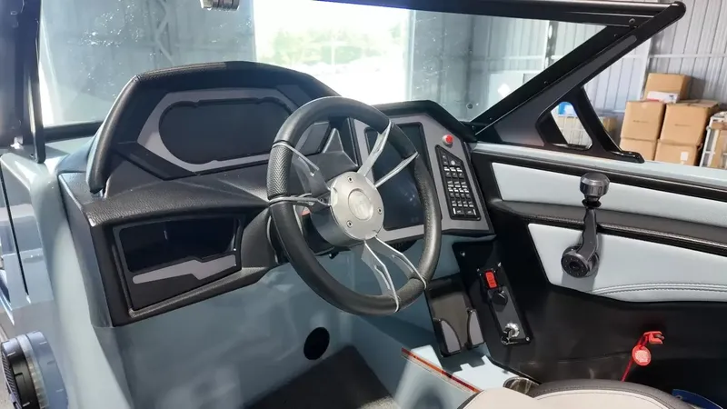 Slide: The Image of The image shows the cockpit of a 2024 MasterCraft XStarS boat with a modern steering wheel and dashboard. - 45