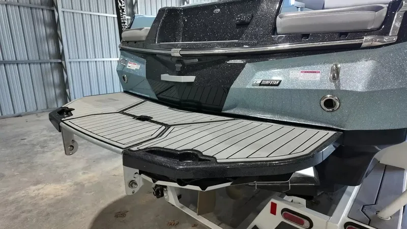 Slide: The Image of The image shows the rear of a 2024 MasterCraft XStarS boat in a storage facility. - 5