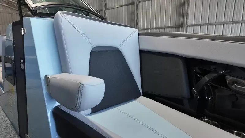 Slide: The Image of The interior of a 2024 MasterCraft XStarS features a sleek, upholstered seat with blue and gray accents. - 26