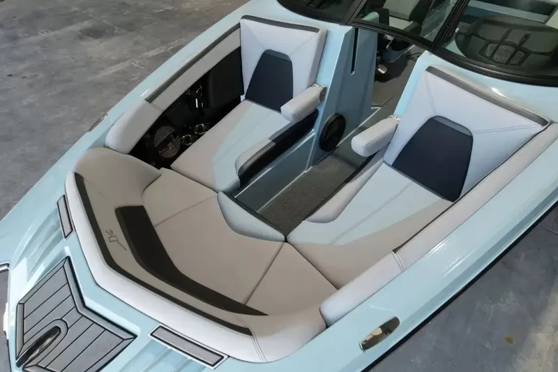 Slide: The Image of The image shows the cockpit of a 2024 MasterCraft XStarS with luxurious, light-colored padded seats. - 23