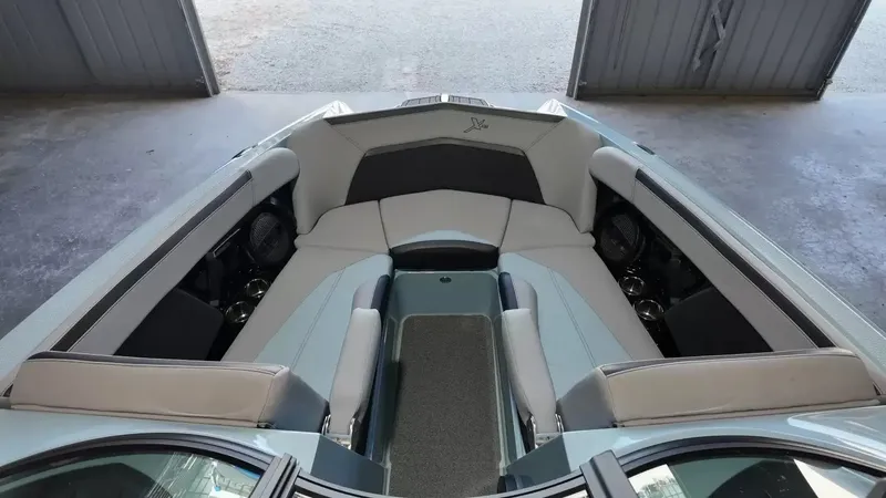Slide: The Image of The image shows the bow area of a 2024 MasterCraft XStarS with gray upholstery. - 29