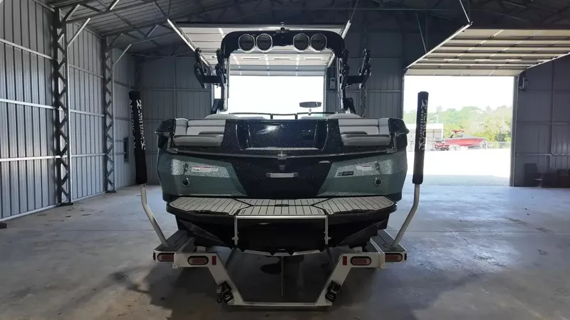 Slide: The Image of A 2024 MasterCraft XStarS in an open warehouse. The boat features a modern design. - 9