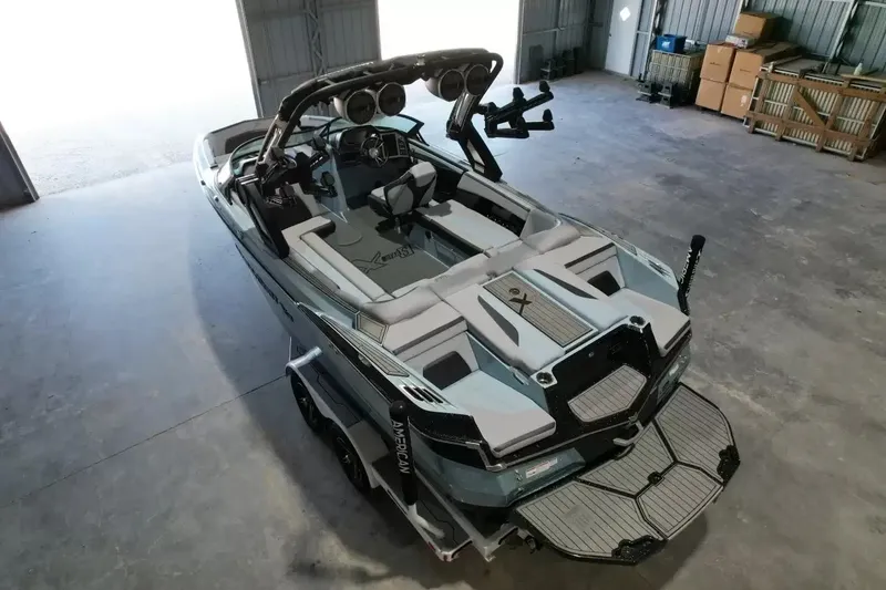 Slide: The Image of The image shows a 2024 MasterCraft XStarS boat in a warehouse. - 14