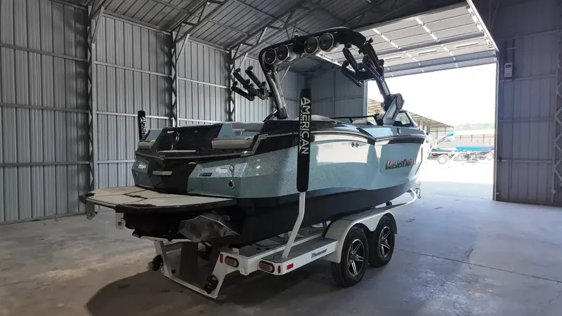 Slide: The Image of A 2024 MasterCraft XStarS boat on a trailer inside a storage facility. - 4