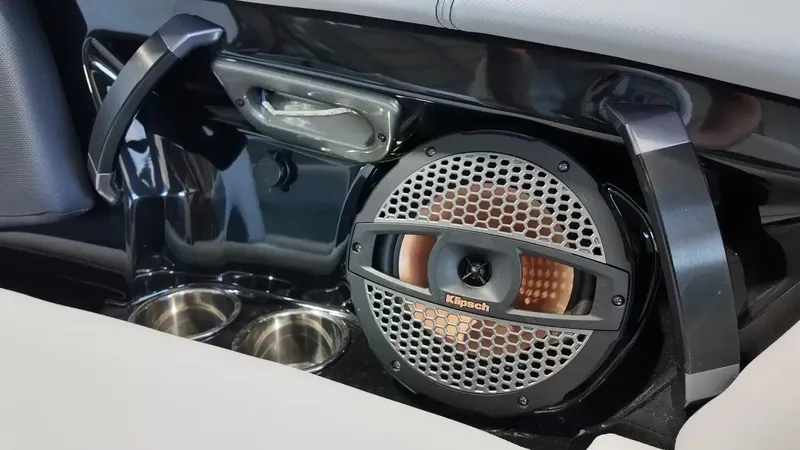 Slide: The Image of Close-up of a speaker and cup holders in a 2024 MasterCraft XStarS boat. - 28