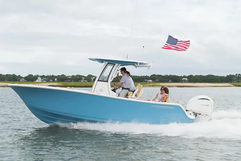 Slide: The Image of A blue 2025 Sportsman Open 232 Center Console boat on the water. Two people are on board. - 18